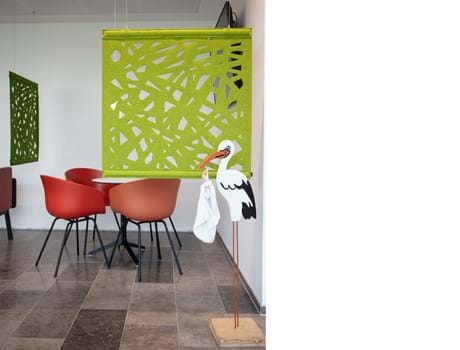 grøn rumdeler i filt i venterum på sygehus